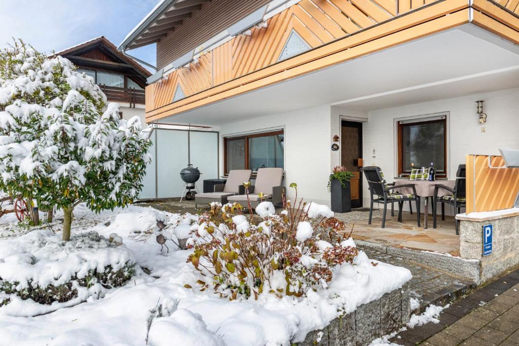 a house in the snow with a table and chairs at Ferienwohnung Behling in Frickingen