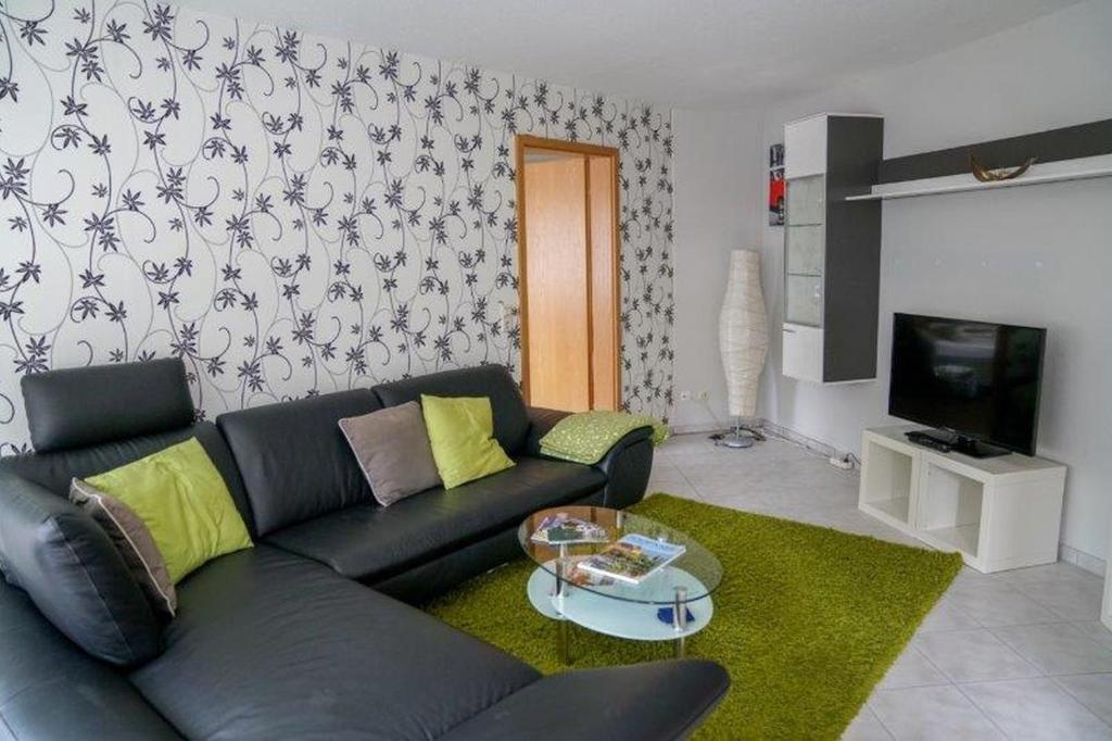 a living room with a couch and a tv at Ferienwohnung Roth in Frickingen