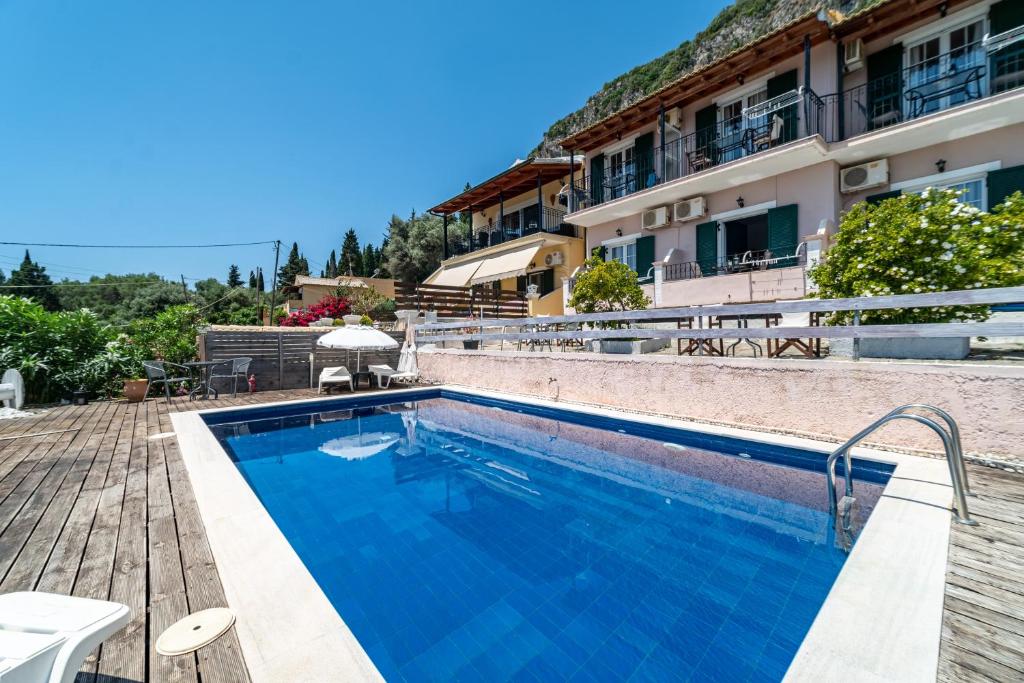 a swimming pool in front of a building at Spyridoula Studio 4 in Paleokastritsa