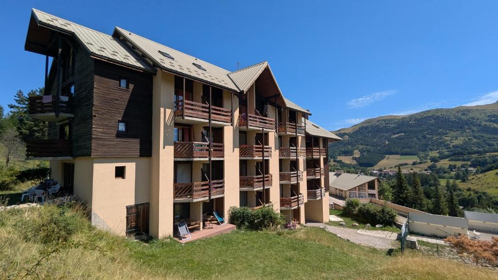 a building on the side of a hill at Les Cimes - La Canopée in Gresse-en-Vercors