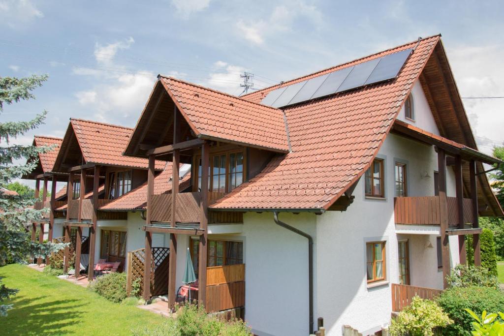 a row of houses with solar panels on their roofs at Ferienhaus Behler in Kressbronn am Bodensee