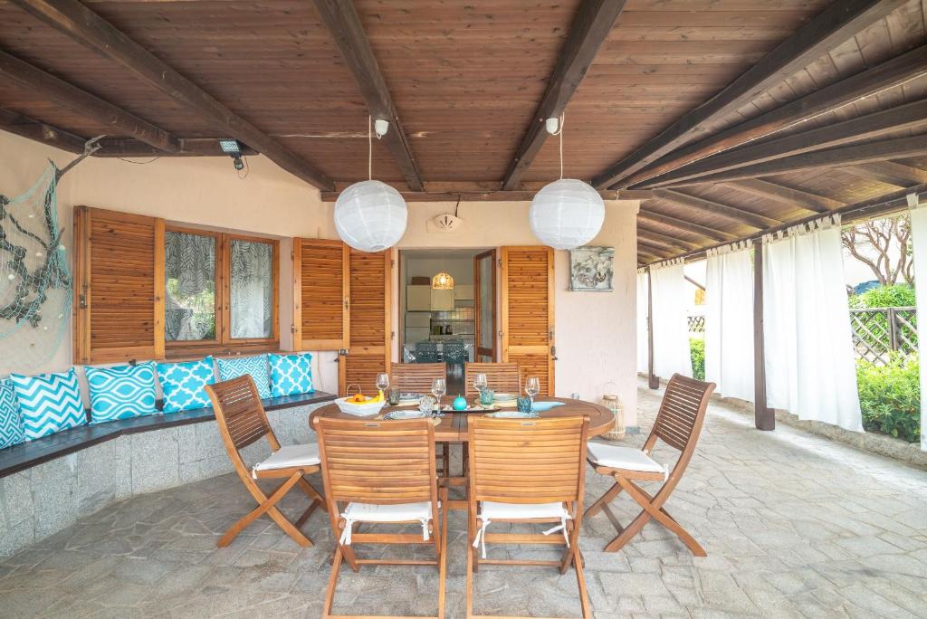a patio with a wooden table and chairs at Villa Clelia in Palau