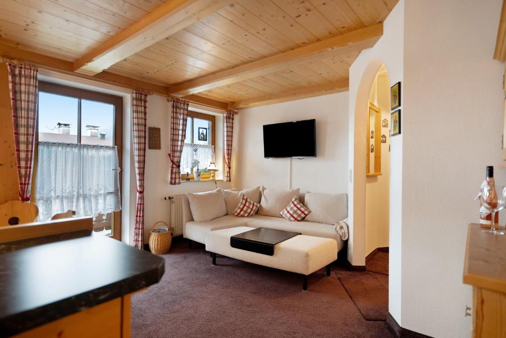a living room with a couch and a table at Ferienwohnung Huttenberg in Reit im Winkl