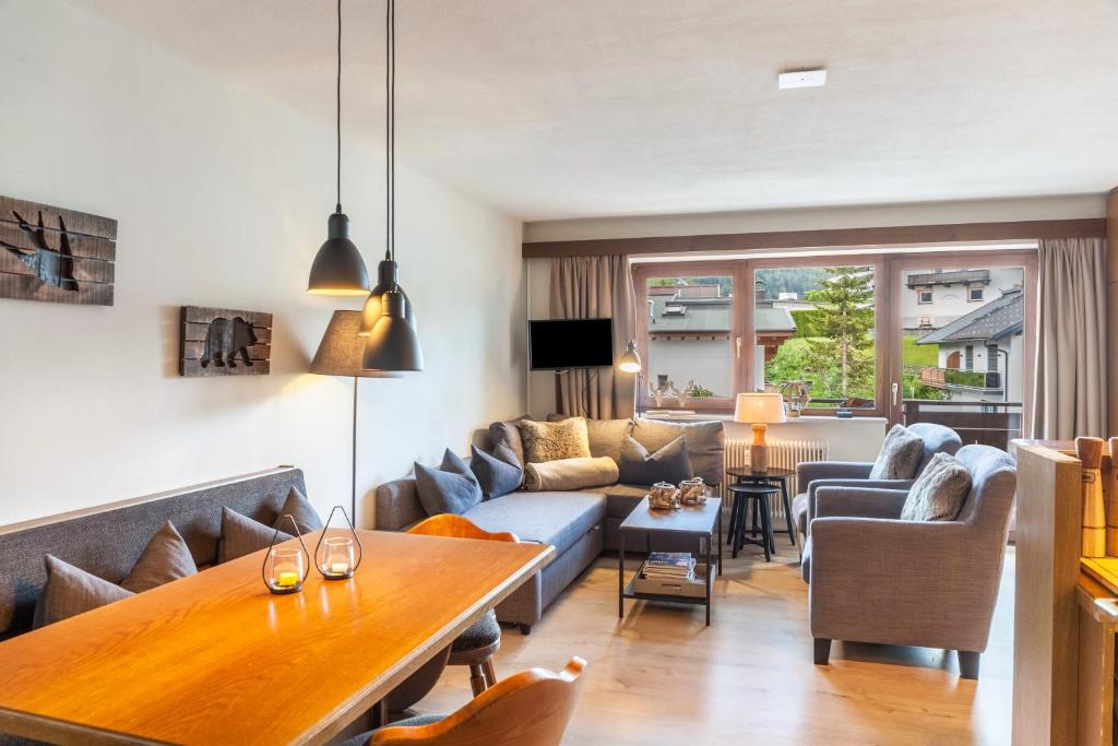 a living room with a couch and a table at Haus Excelsior Top 31 in Seefeld in Tirol