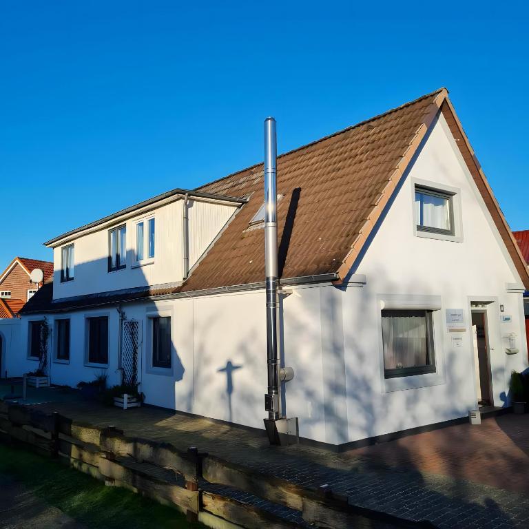 a white house with a brown roof at Haus Laffina in Büsum
