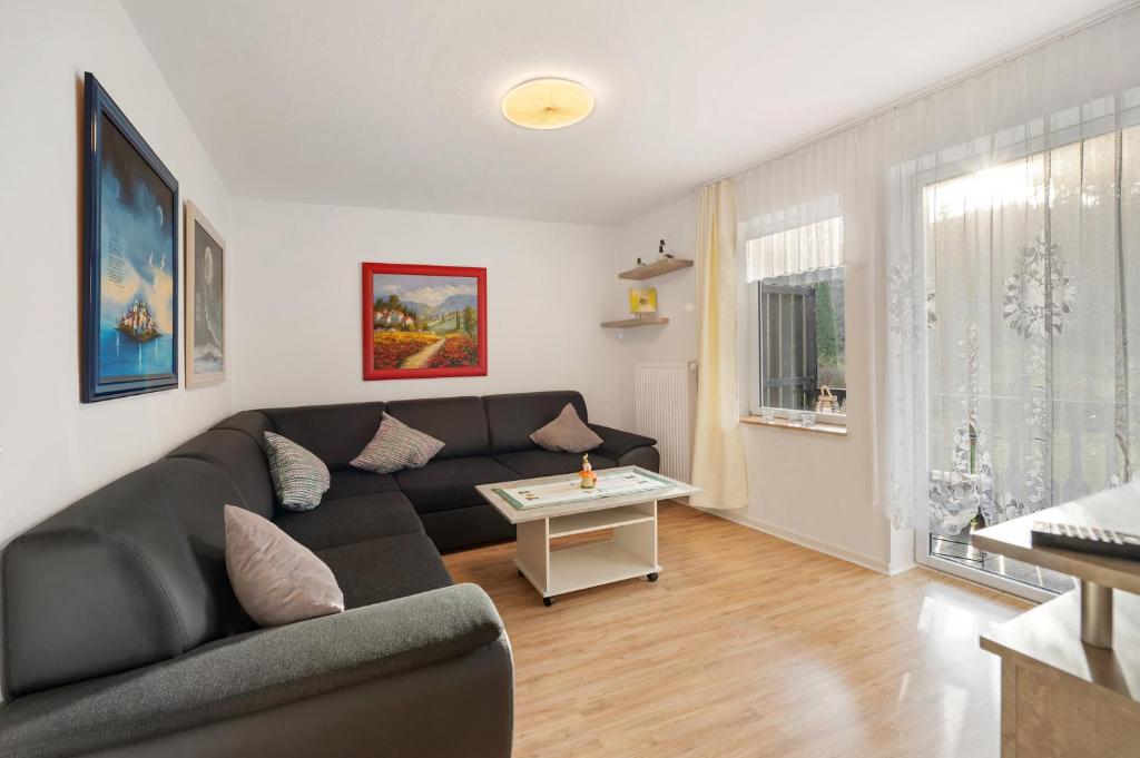 a living room with a couch and a table at Haus Annenberg in Monzelfeld