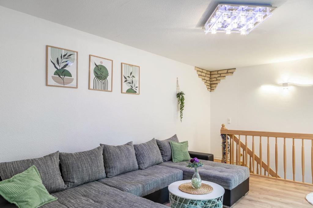 a living room with a gray couch and a table at Ferienhaus Bernoth in Erfurt
