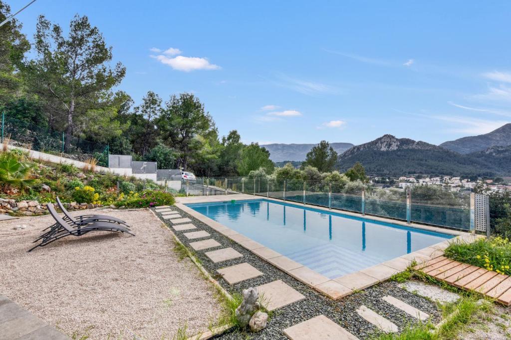 a swimming pool with a view of the mountains at Villa Sol in Orba
