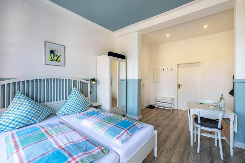 a bedroom with a bed and a table and a desk at Schweden Apartment in Kerken