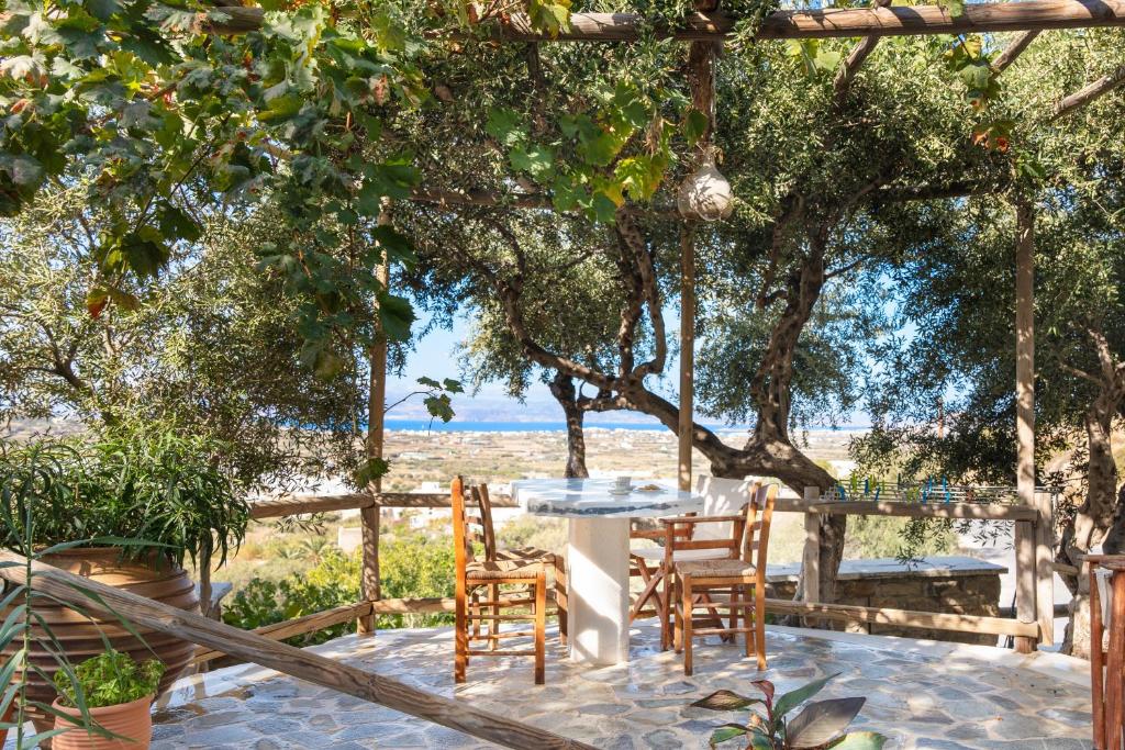 a table and chairs on a patio under a tree at Elysium in Glinádhon