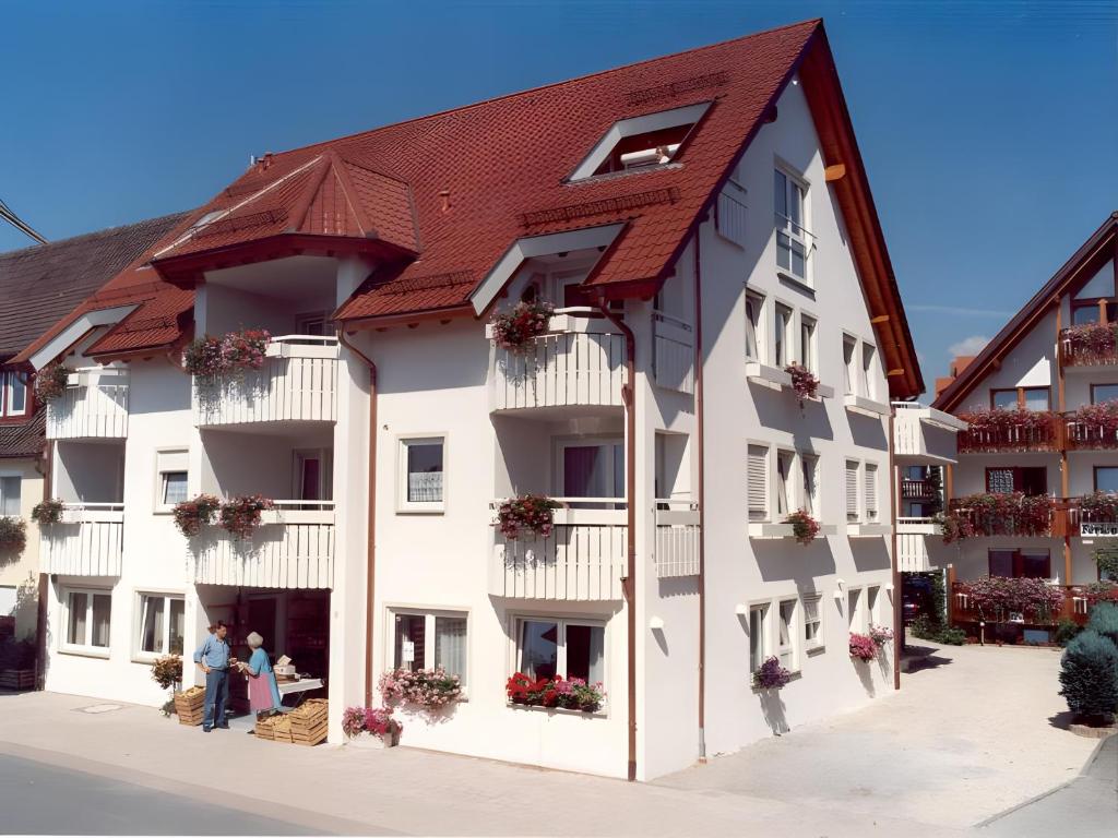 a large white building with a red roof at Sommerhof Rauber in Immenstaad am Bodensee