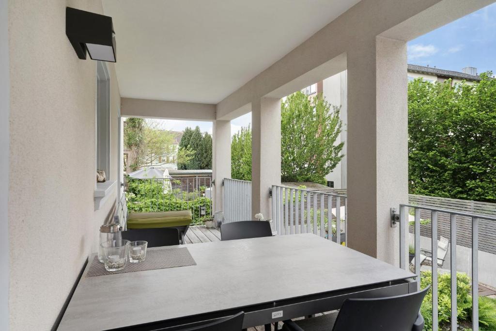 an outdoor patio with a table and chairs on a balcony at Haus No 6 in Lahr