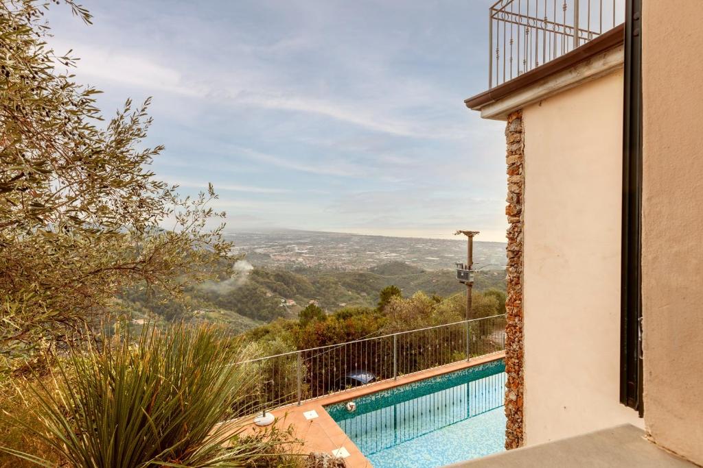 a view from the balcony of a house with a swimming pool at Villa Martina in Pietrasanta