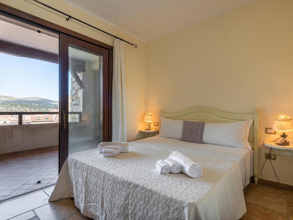 a bedroom with a bed with two towels on it at Maison Pinella in Villasimius