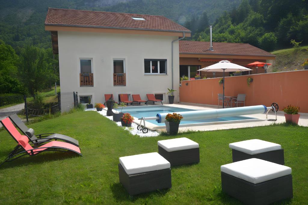 a house with a yard with a swimming pool at La Chambre De Jaxel in Saint-Martin-en-Vercors