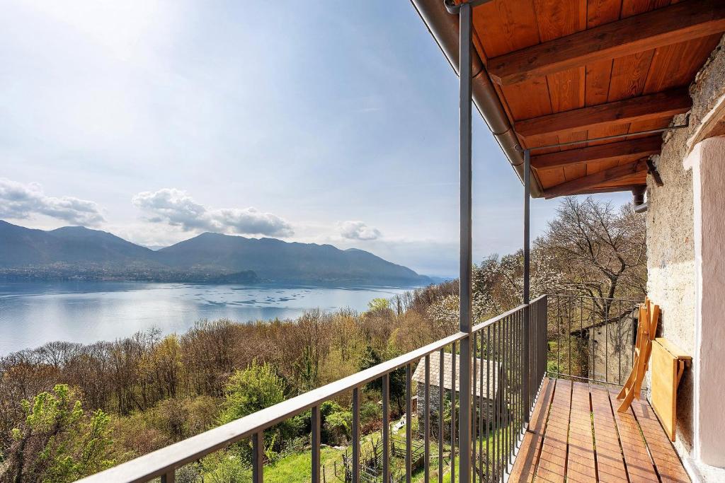 a balcony of a house with a view of a lake at La torretta di Mozzola in Oggebio