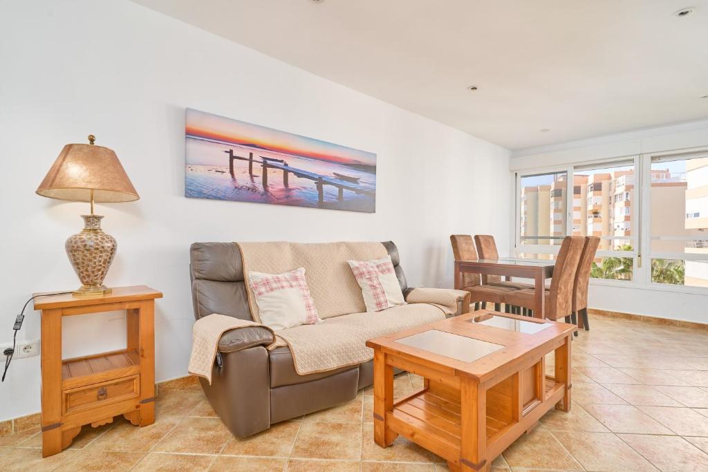 a living room with a couch and a table at Apto Urb Centro Internacional A117 in Torrox