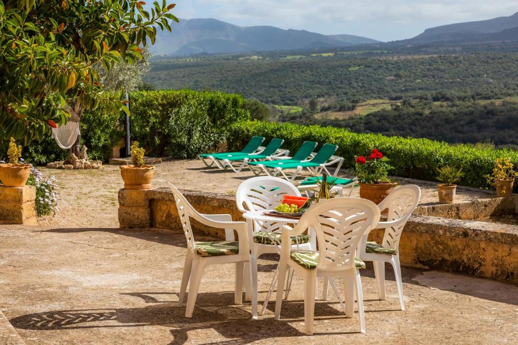 a group of chairs and a table with a view at Finca Ses Coves in Petra
