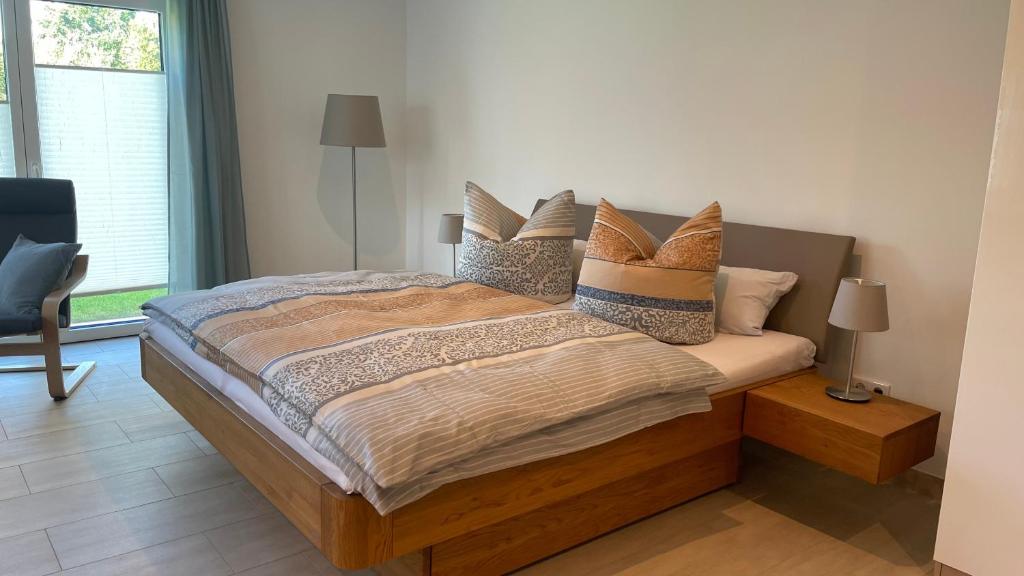 a bedroom with a large bed with pillows on it at Ferienwohnung Am Wall in Radeberg