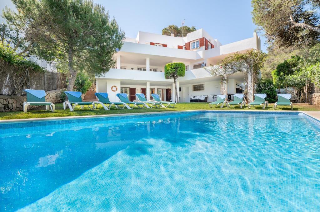 a villa with a swimming pool and a house at Villa Es Cantò in Cacla D'or
