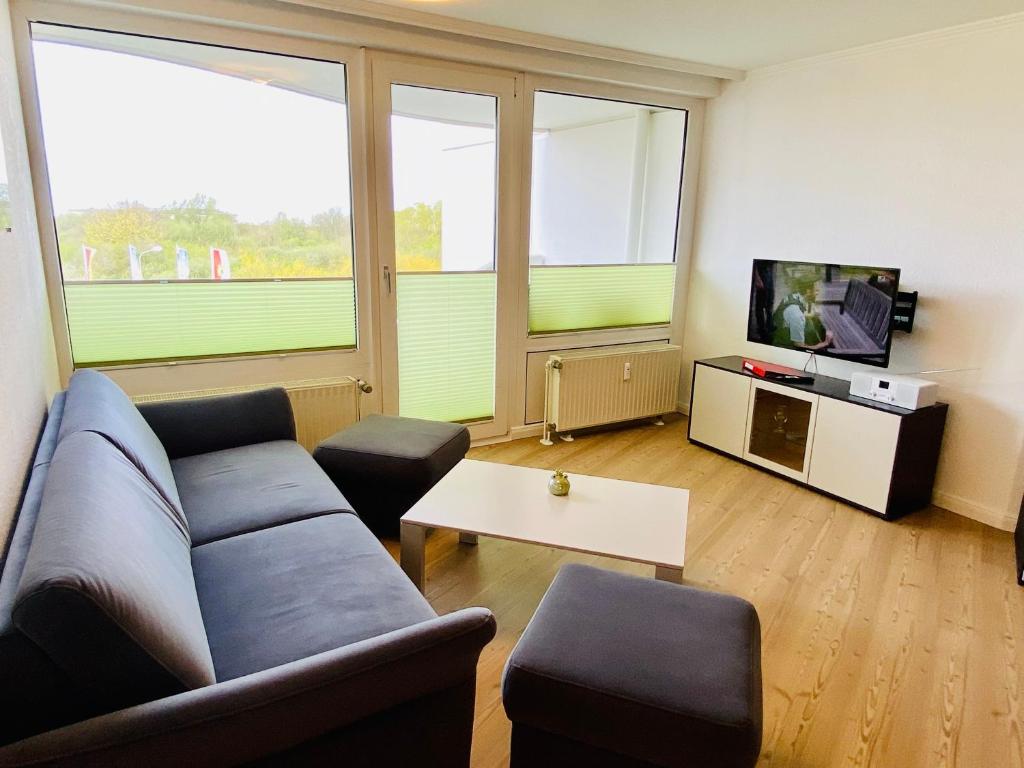 a living room with a couch and a tv at 307 im Lord Nelson in Cuxhaven