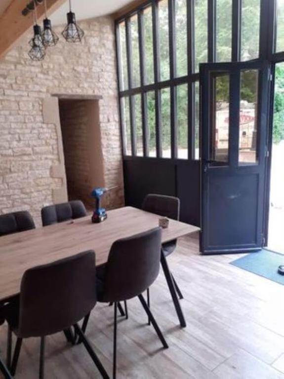 a large room with a wooden table and chairs at Domaine du Val Bruant in Arc-en-Barrois