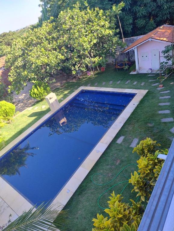 a swimming pool in the yard of a house at Casa da Mari in Caucaia