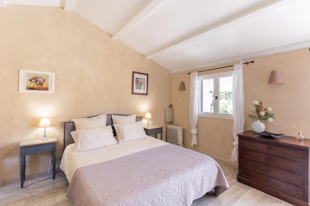 a bedroom with a bed and two tables and a window at Santa Maria in Manso