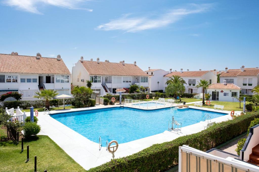 a swimming pool in a villa with houses at Estudio Bloque 90 in Torrox