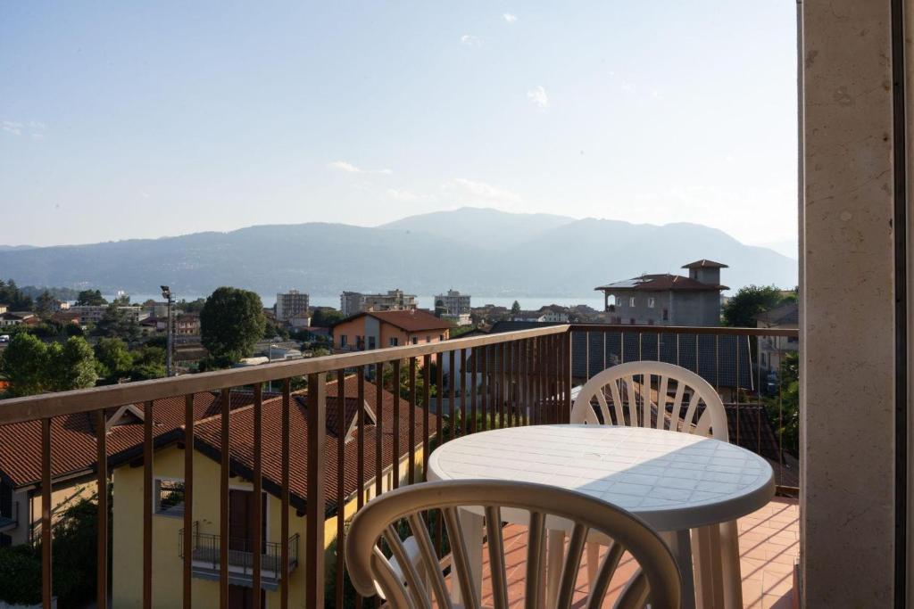 a table and chairs on a balcony with a view at Verbania Panorama Lago in Verbania