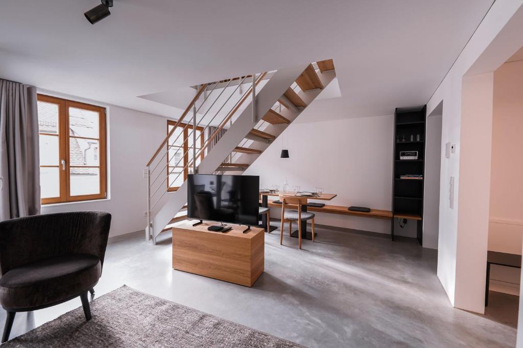 a living room with a tv and a table at 4 Personen Apartment 47 in Überlingen