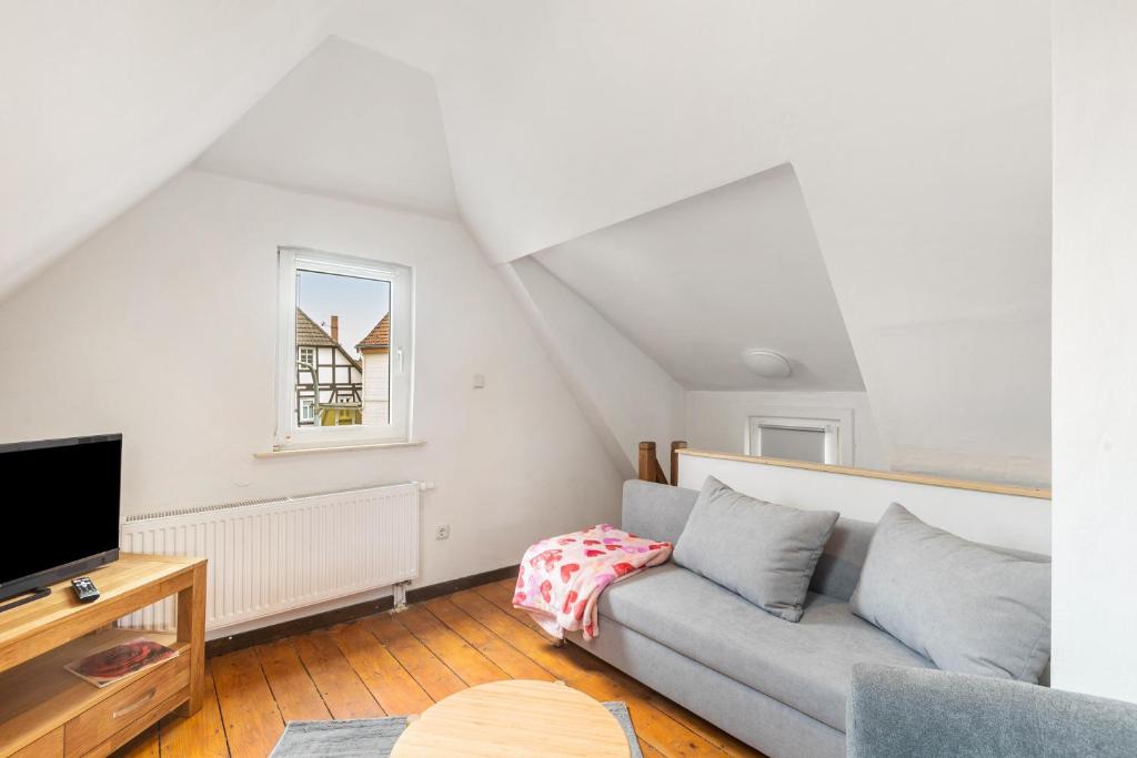 a living room with a couch and a tv at Ferienhaus Feußner in Lauterbach
