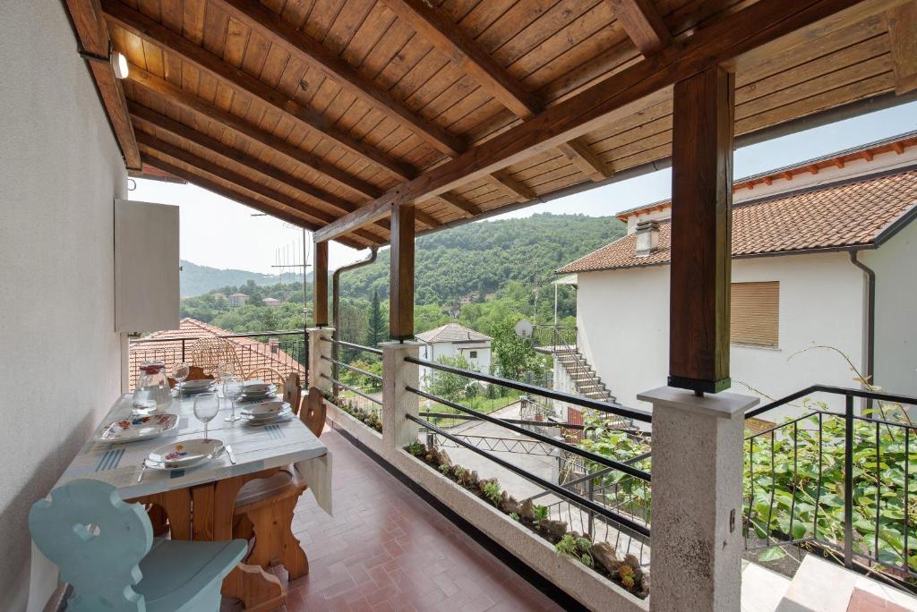 a balcony of a house with a table and a view at Villino Chiara in Pannesi