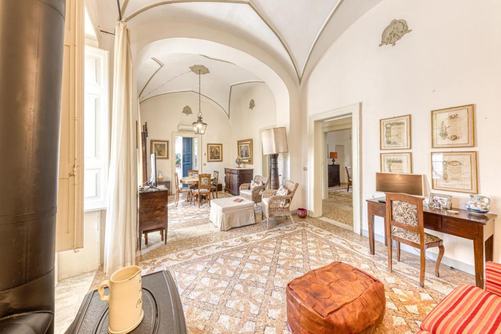 a large living room with a table and a desk at Luisa in Leuca