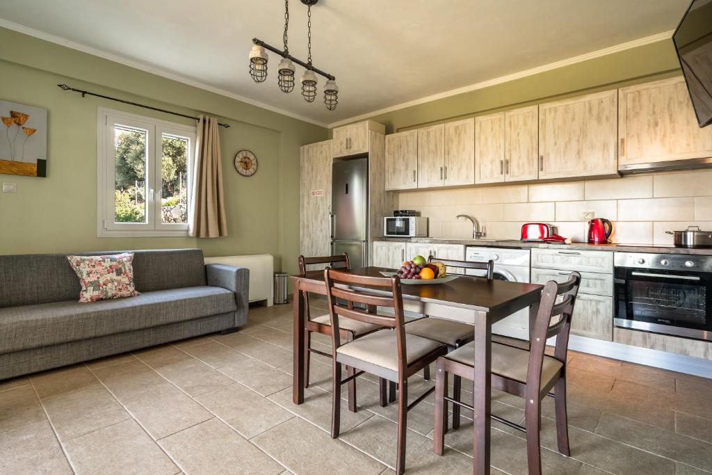 a kitchen with a table and chairs and a couch at Zoi apartment in Kefallonia