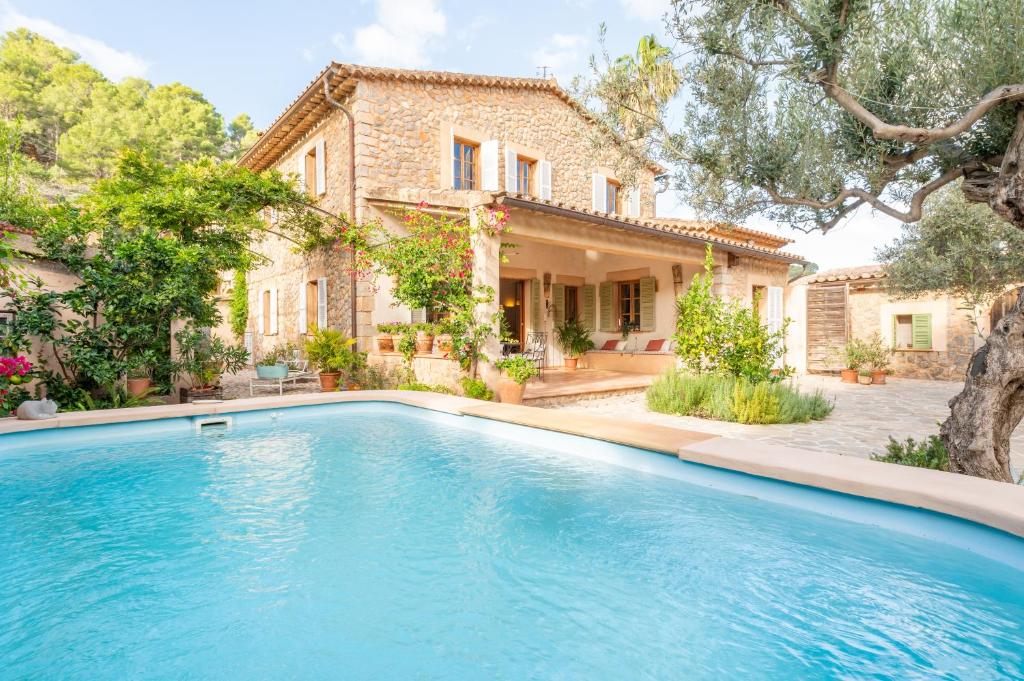 a swimming pool in front of a house at Casa Amber in Sóller