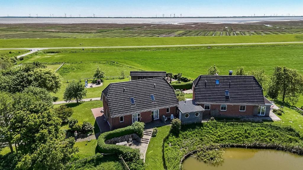 an aerial view of a house in a field at Haushälfte Süderhafen in Nordstrand