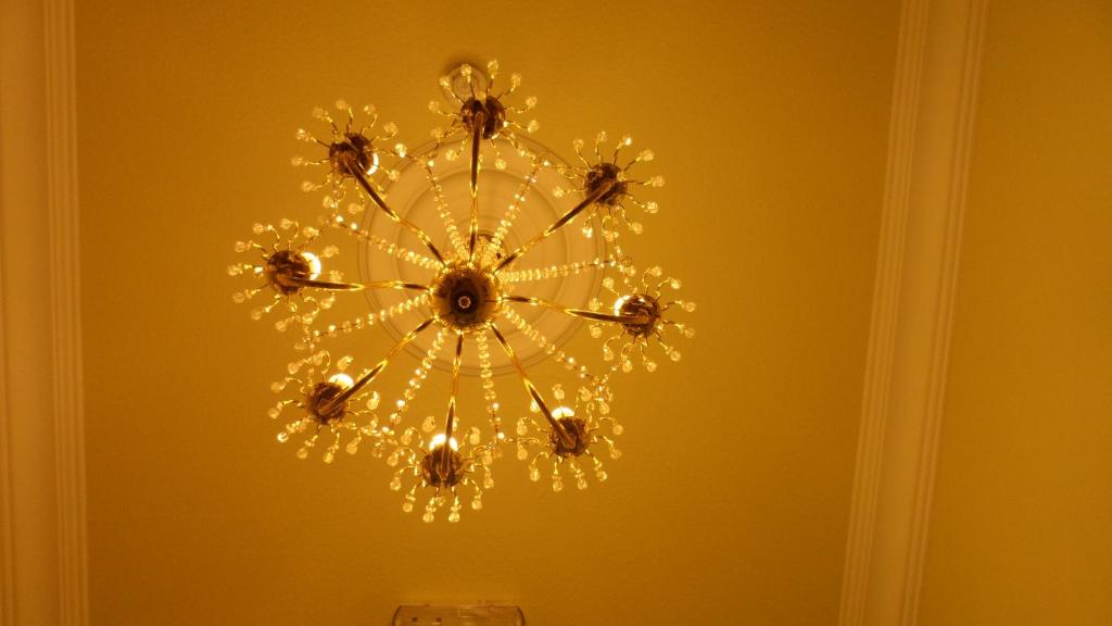 a chandelier hanging from a yellow wall at Gabriel House Guesthouse in Cork