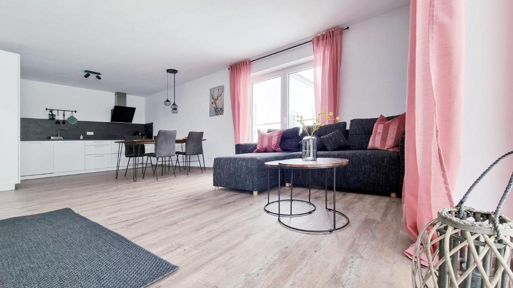 a living room with a couch and a table at Rehkitz in Baiersbronn