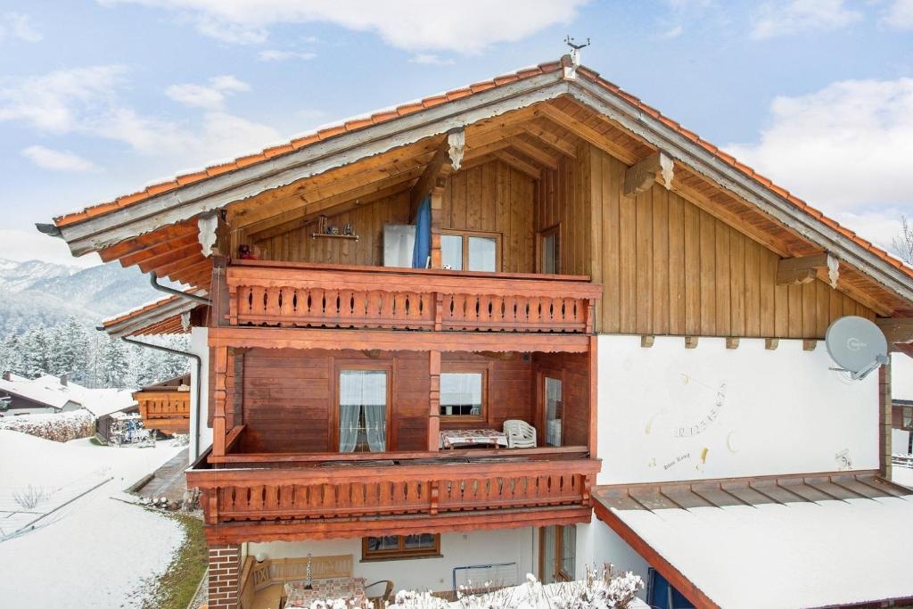 a log house in the snow at Ferienwohnung König im Obergeschoss in Berchtesgaden