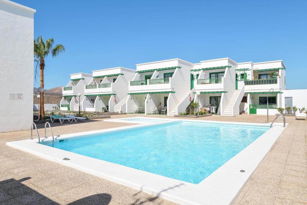 a swimming pool in front of a building at Mimosa B1 in Puerto del Carmen