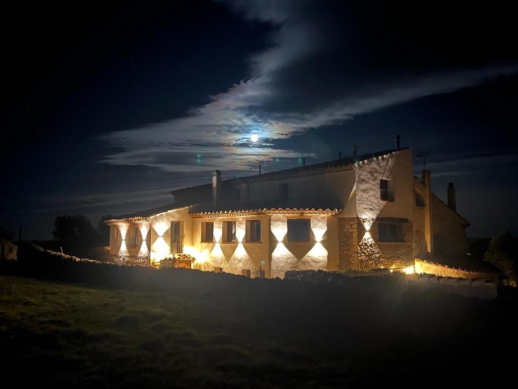 a house lit up at night with lights on it at Masía La Parreta in Villafranca del Cid