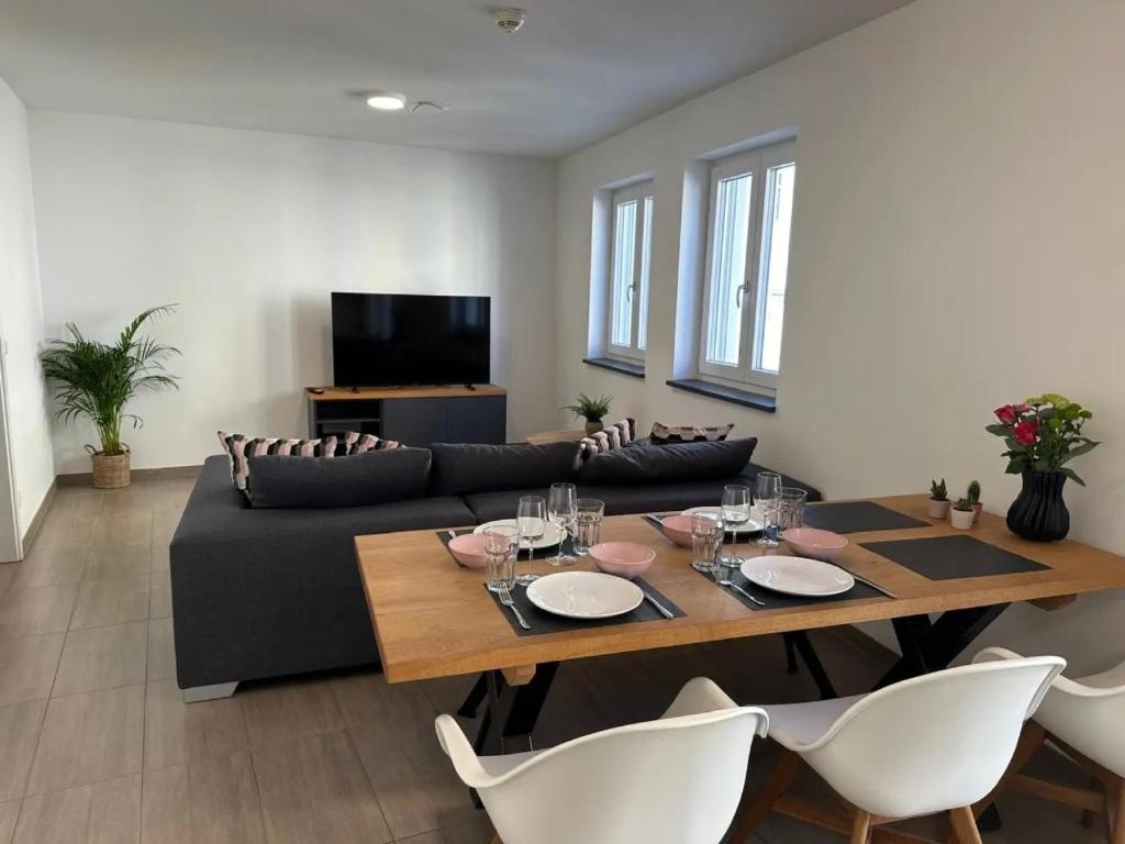 a living room with a table and a couch at Wohnung 4 Rosenstraße in Cham