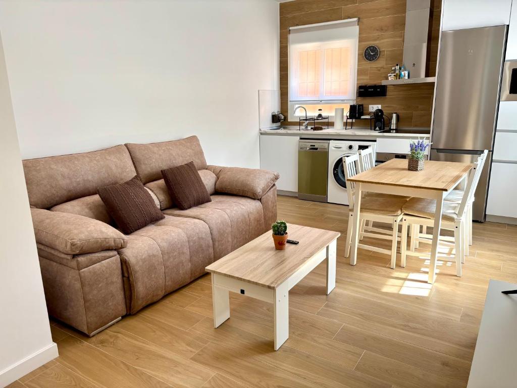 a living room with a couch and a table and a kitchen at La Coqueta in Zarandona