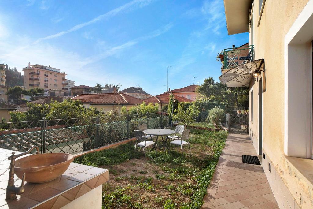 a balcony of a house with a table and chairs at Santa Lucia in Imperia