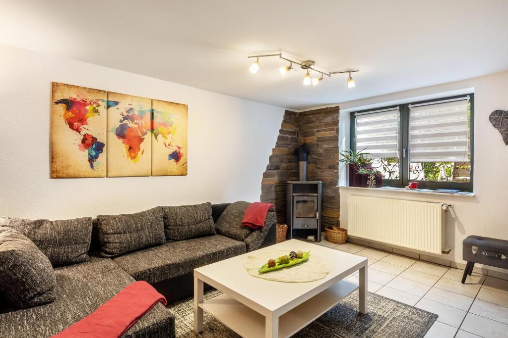 a living room with a couch and a table at Ferienwohnung Boddenberg in Waldbröl