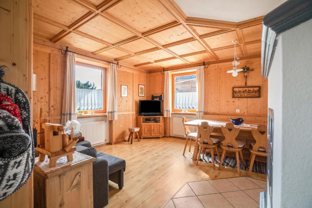 a living room with a table and a dining room at Mendelhaus in Mendola