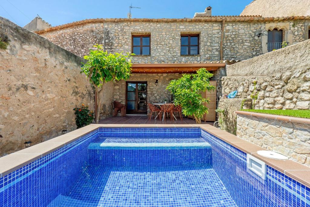 an outdoor swimming pool in front of a house at La Casa Gran Clariana in Gornal