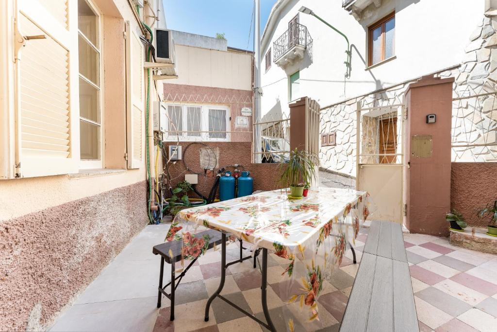 a patio with a table and chairs in a building at Gustalu in Dorgali