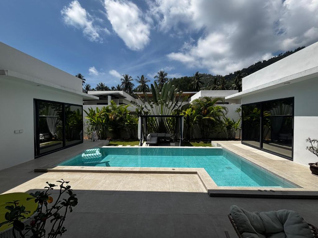 a swimming pool in the backyard of a house at villa du bonheur in Koh Samui